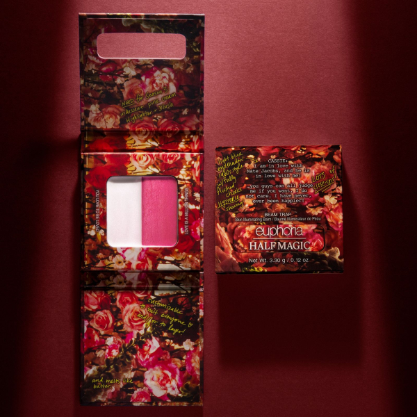 A Half Magic blush and highlighter package against a burgundy background