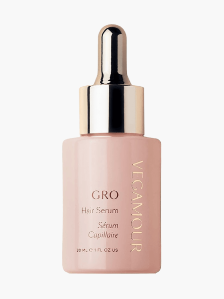 GRO Hair Serum in branded light pink bottle with soft gold pipette on light gray background